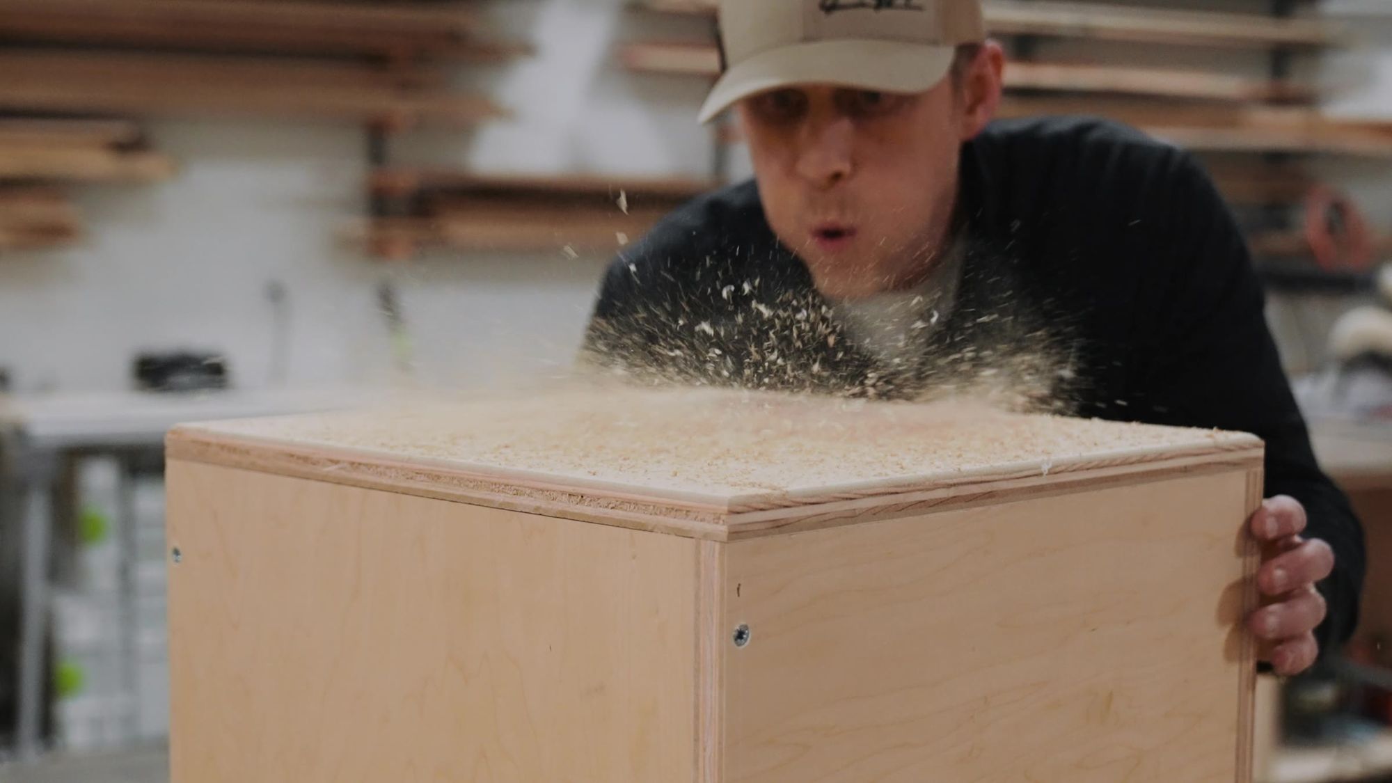 Blowing sawdust off a cabinet box